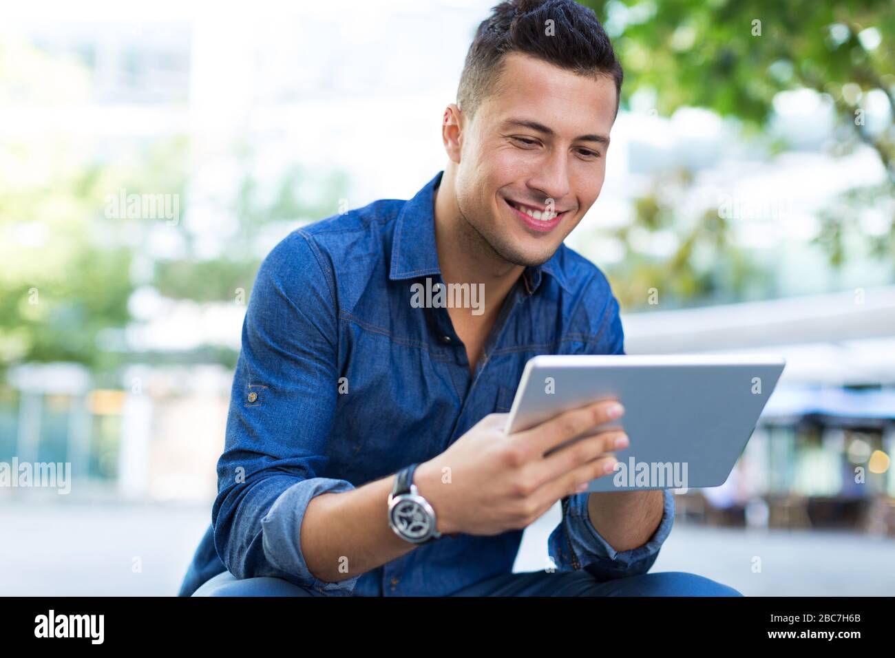 Young man with digital tablet outdoors Stock Photo