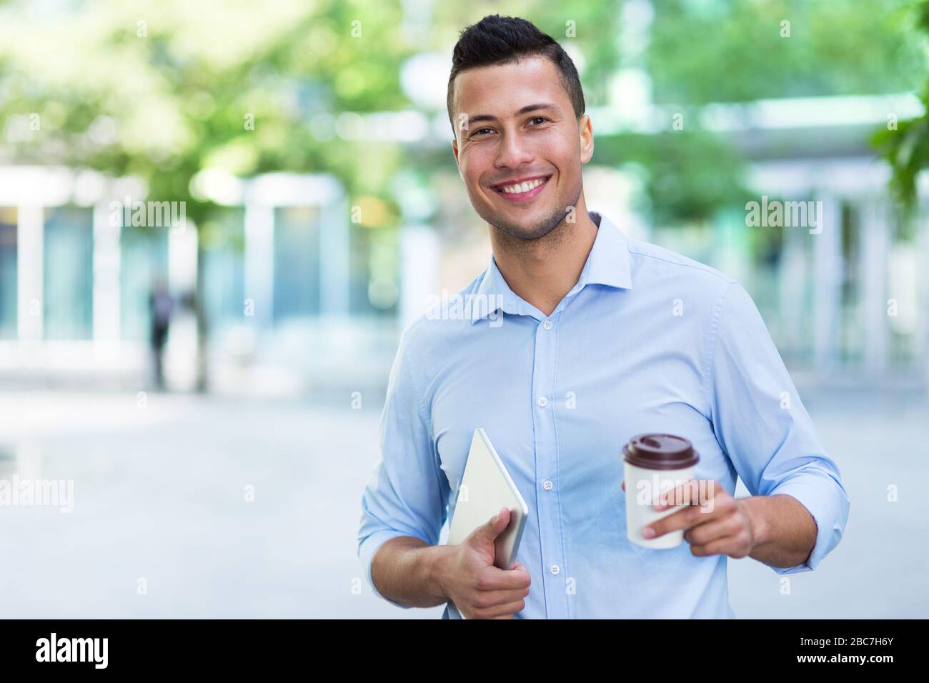 Young man smiling outdoors Stock Photo