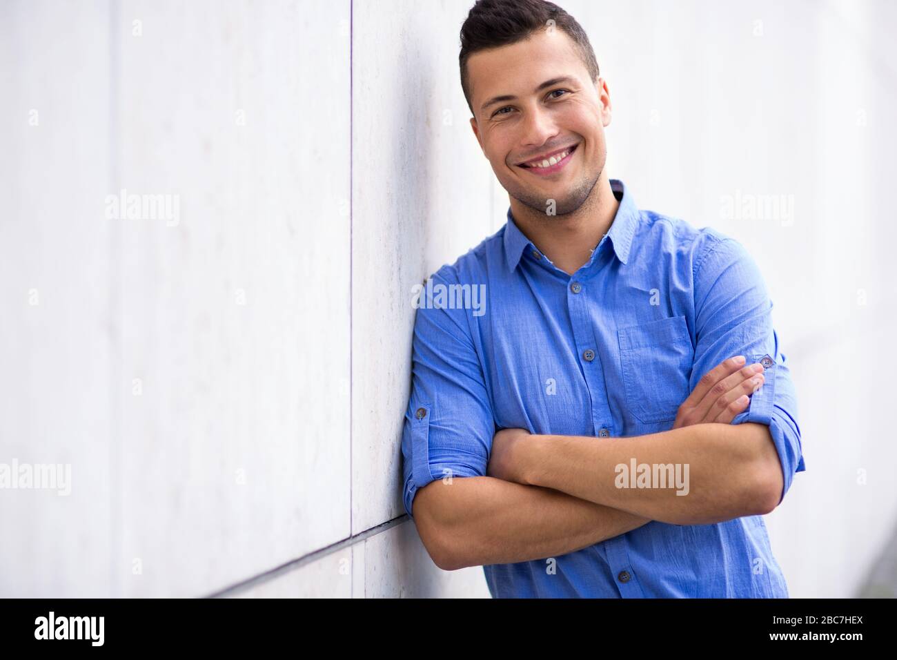 Young man smiling outdoors Stock Photo