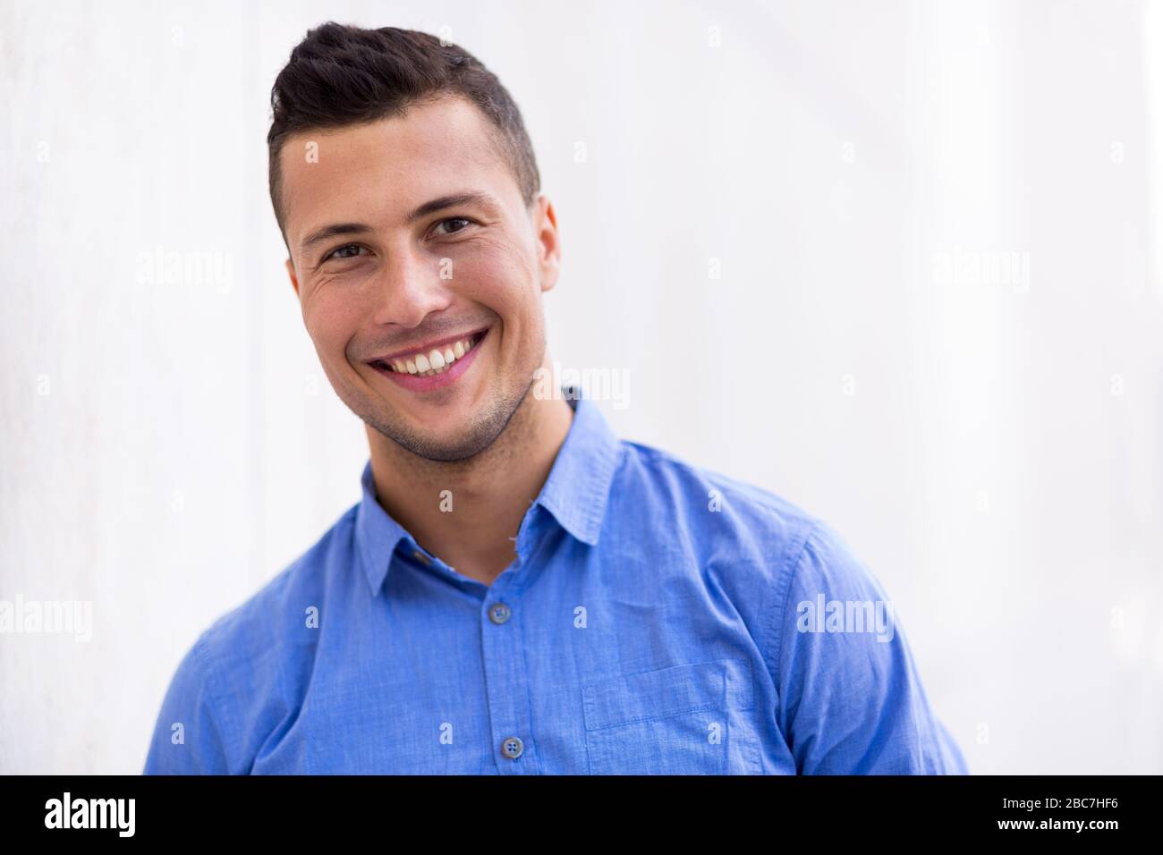 Young man smiling outdoors Stock Photo