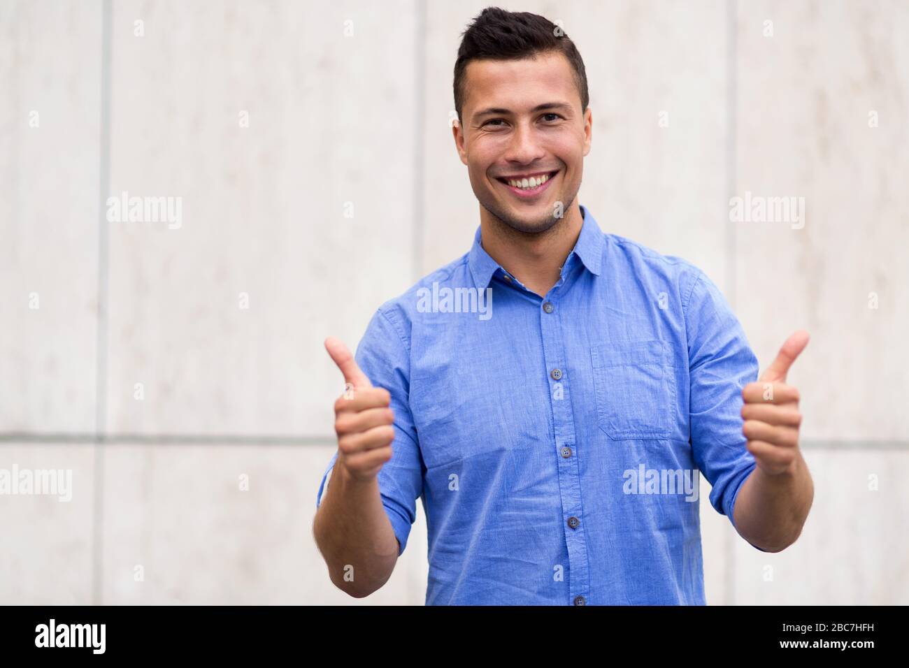 Young man showing thumbs up Stock Photo