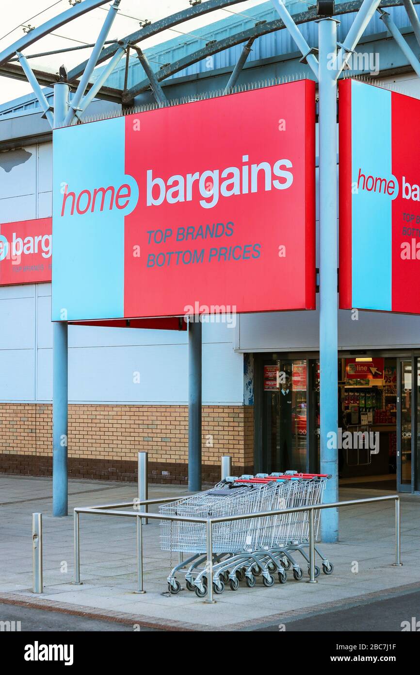Home Bargains general food store entrance with shopping trolleys, Irvine, Ayrshire Stock Photo