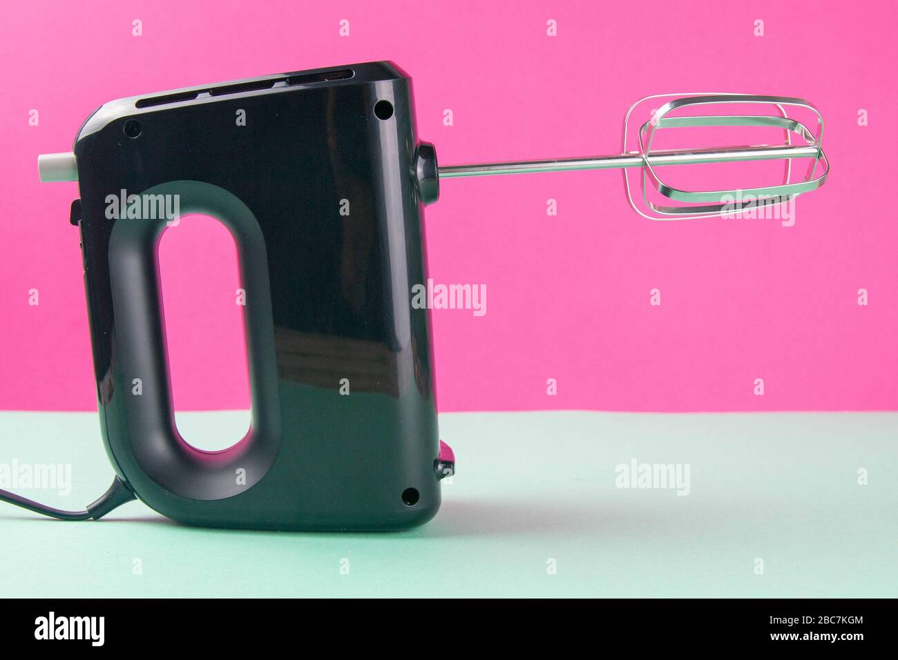 Kitchen electric hand mixer for mixing whip or eggs on white table near