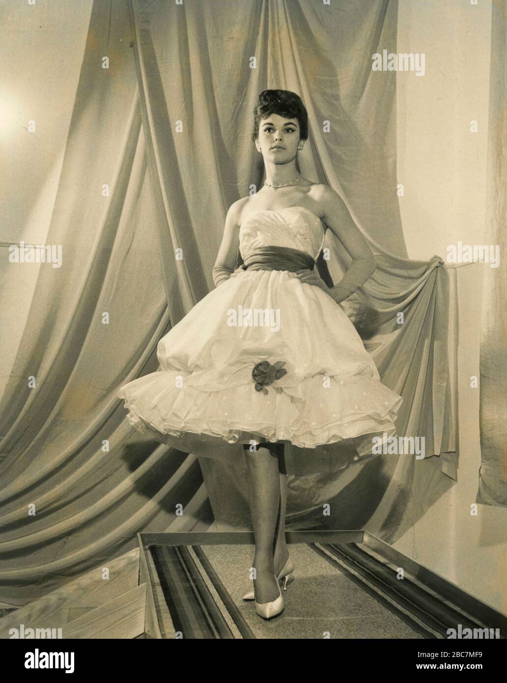 Model from the 1960s presenting an outfit with elegant bubble dress and  long gloves, Italy Stock Photo - Alamy