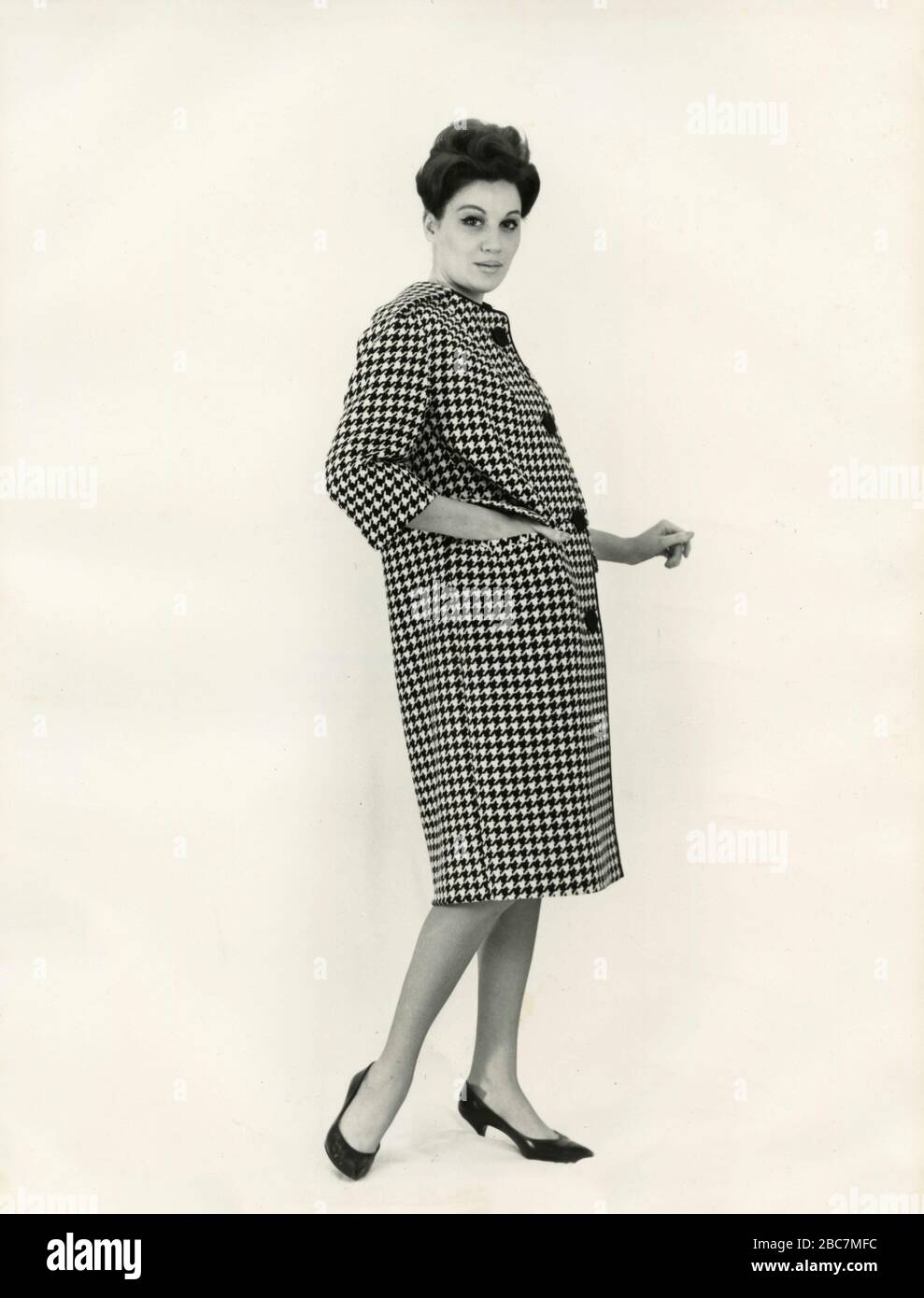 Model from the 1960s presenting an outfit with pied de poule coat, Italy  Stock Photo - Alamy