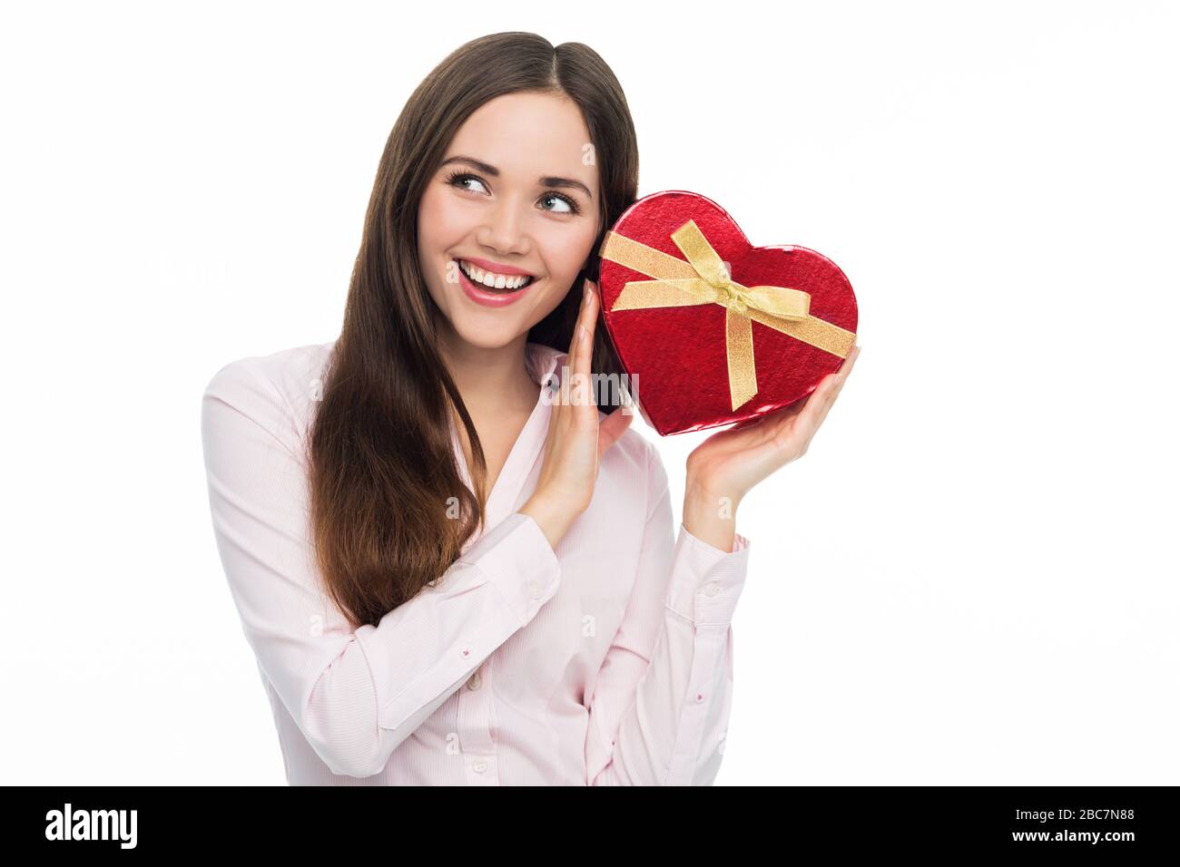 Woman holding heart-shaped box Stock Photo