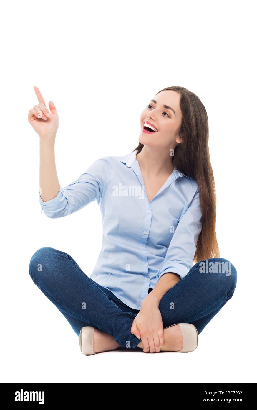 Young woman sitting on white background Stock Photo