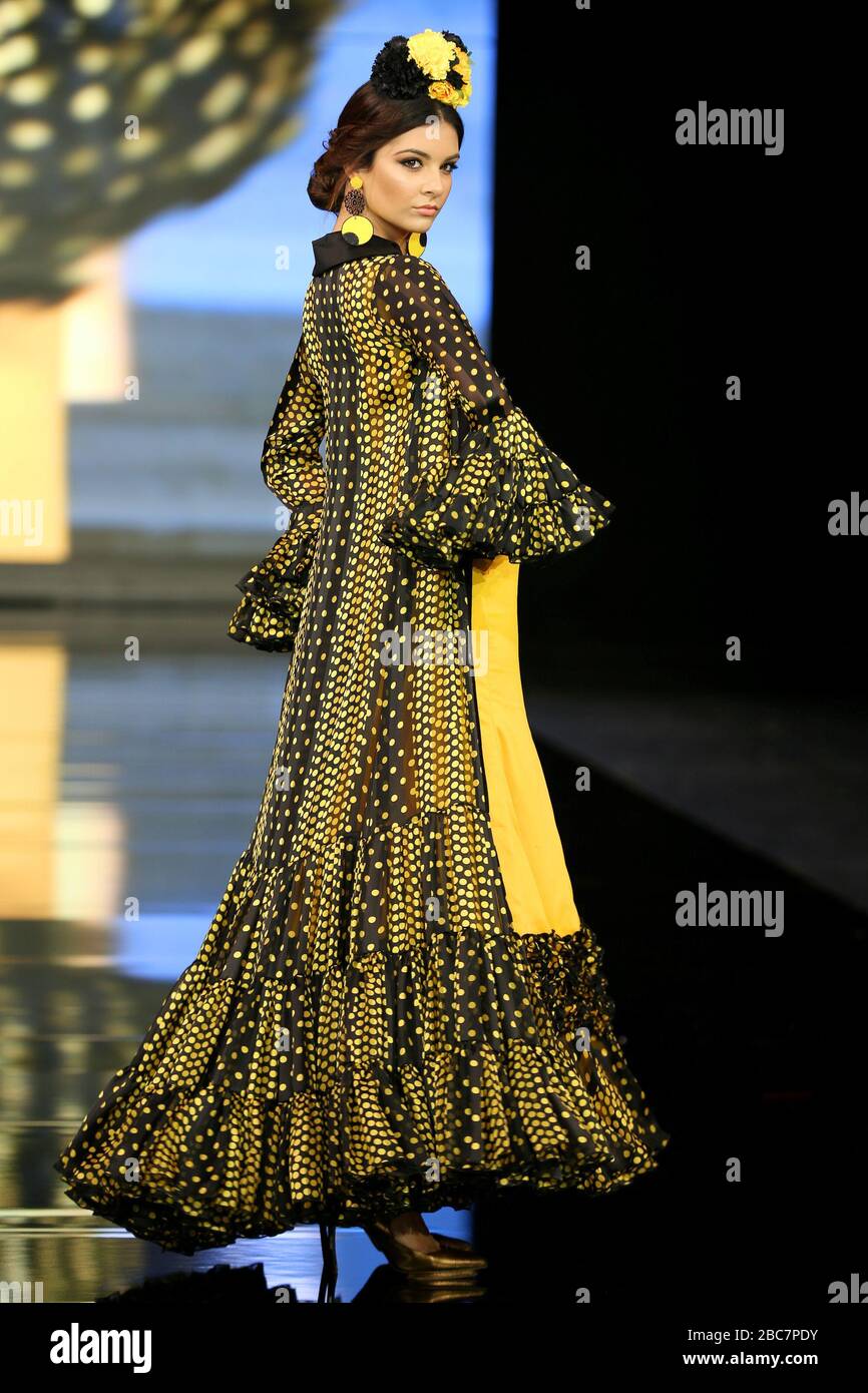 SEVILLA, SPAIN - JAN 30: model Candela Garrido wearing the Yellow dress of the Iridiscencias collection by designer Andrea Cobos during the SIMOF 2020 (Photo credit: Mickael Chavet) Stock Photo