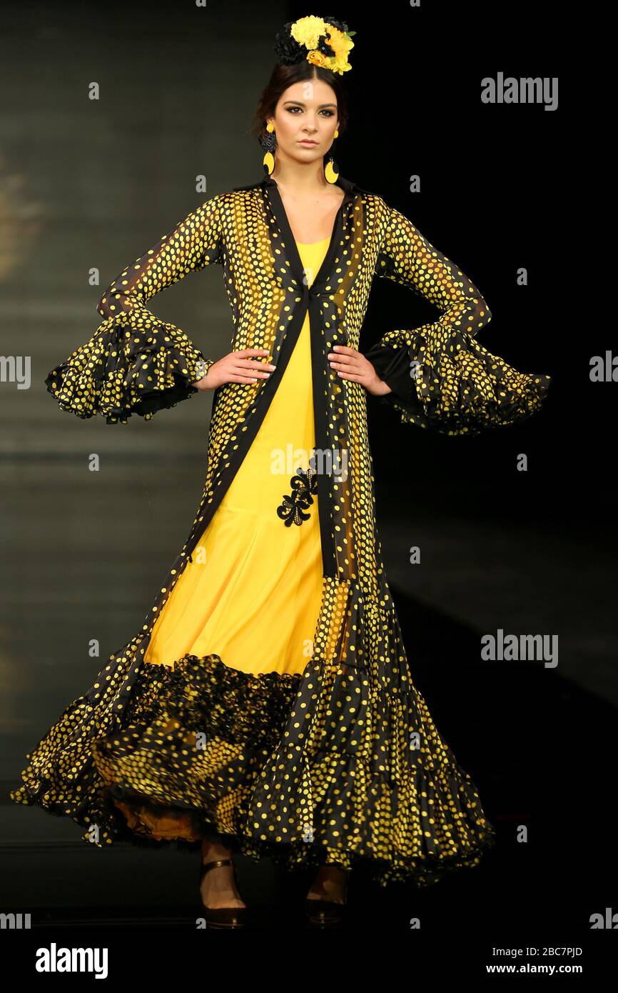 SEVILLA, SPAIN - JAN 30: model Candela Garrido wearing the Yellow dress of the Iridiscencias collection by designer Andrea Cobos during the SIMOF 2020 (Photo credit: Mickael Chavet) Stock Photo