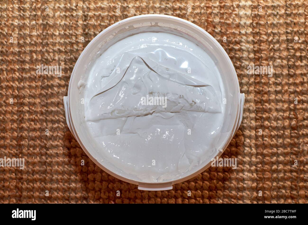 Bucket of white spackle compound shot from top Stock Photo Alamy