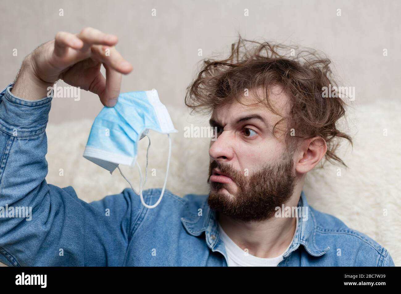 Portrait of a guy with a medical mask that stinks. Bad smell of a ...