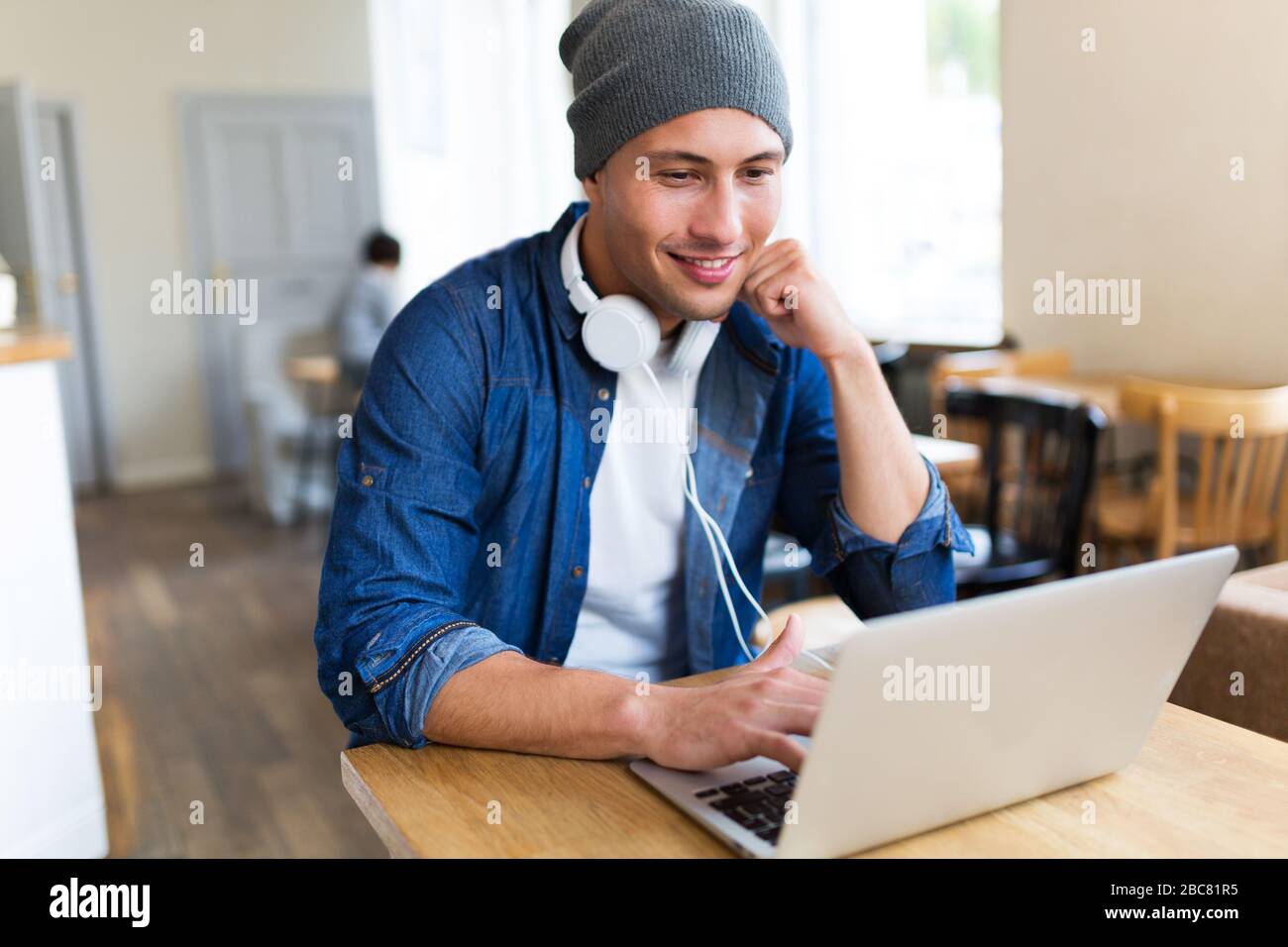 Young man using laptop at cafe Stock Photo