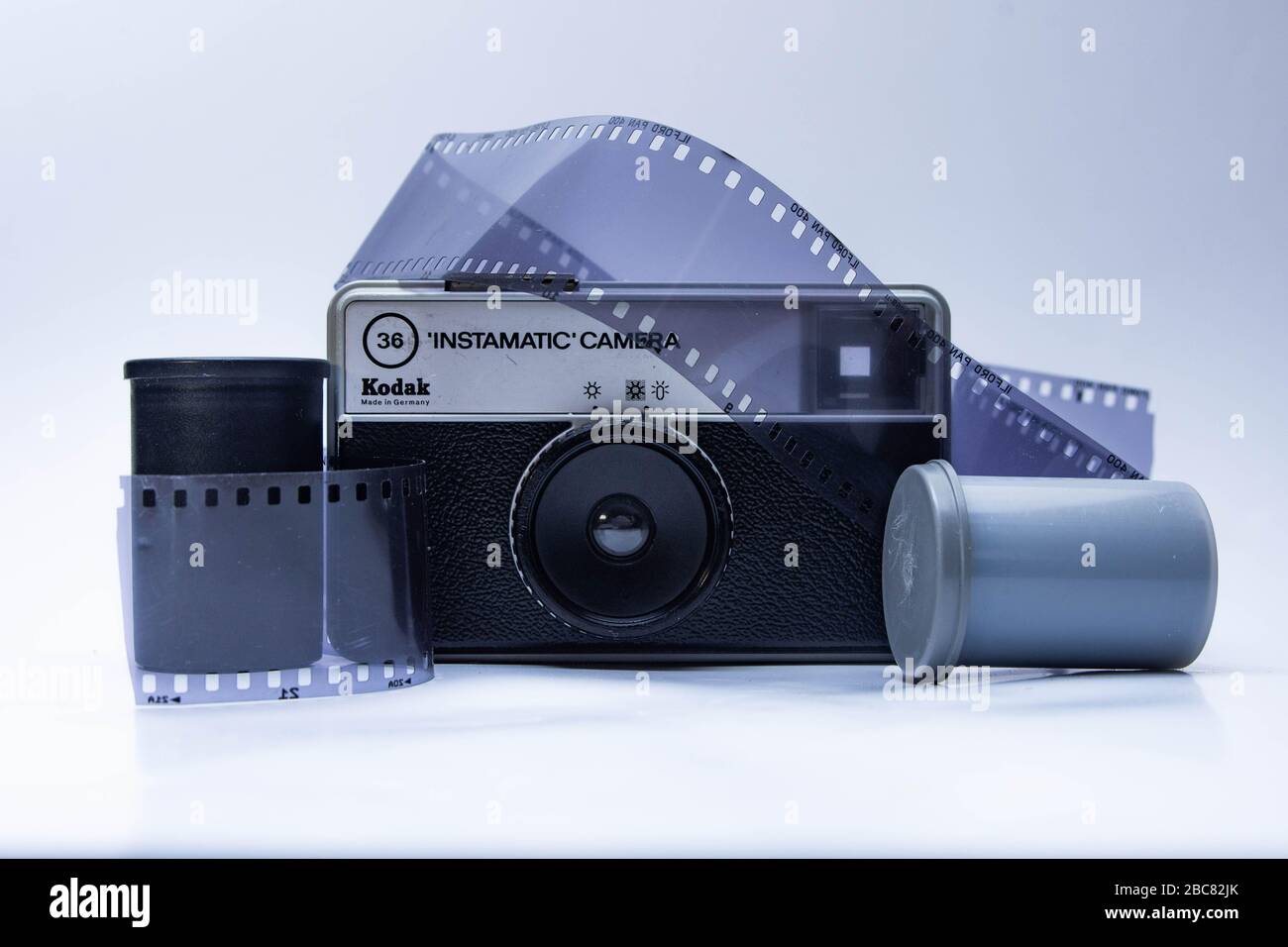 old school 35mm film camera, and camera lenses with film containers and