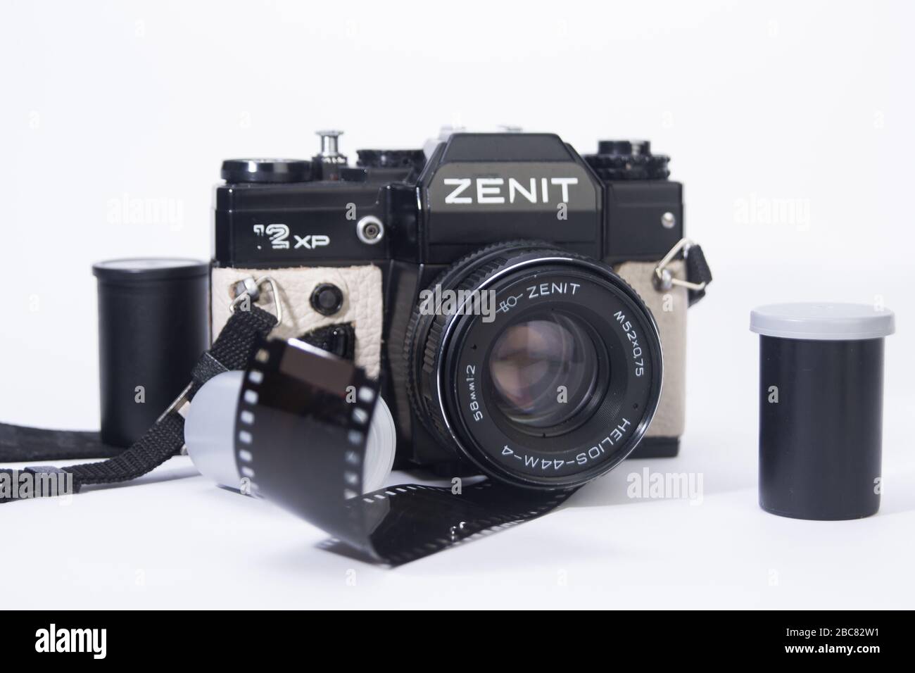 old school 35mm film camera, and camera lenses with film containers and