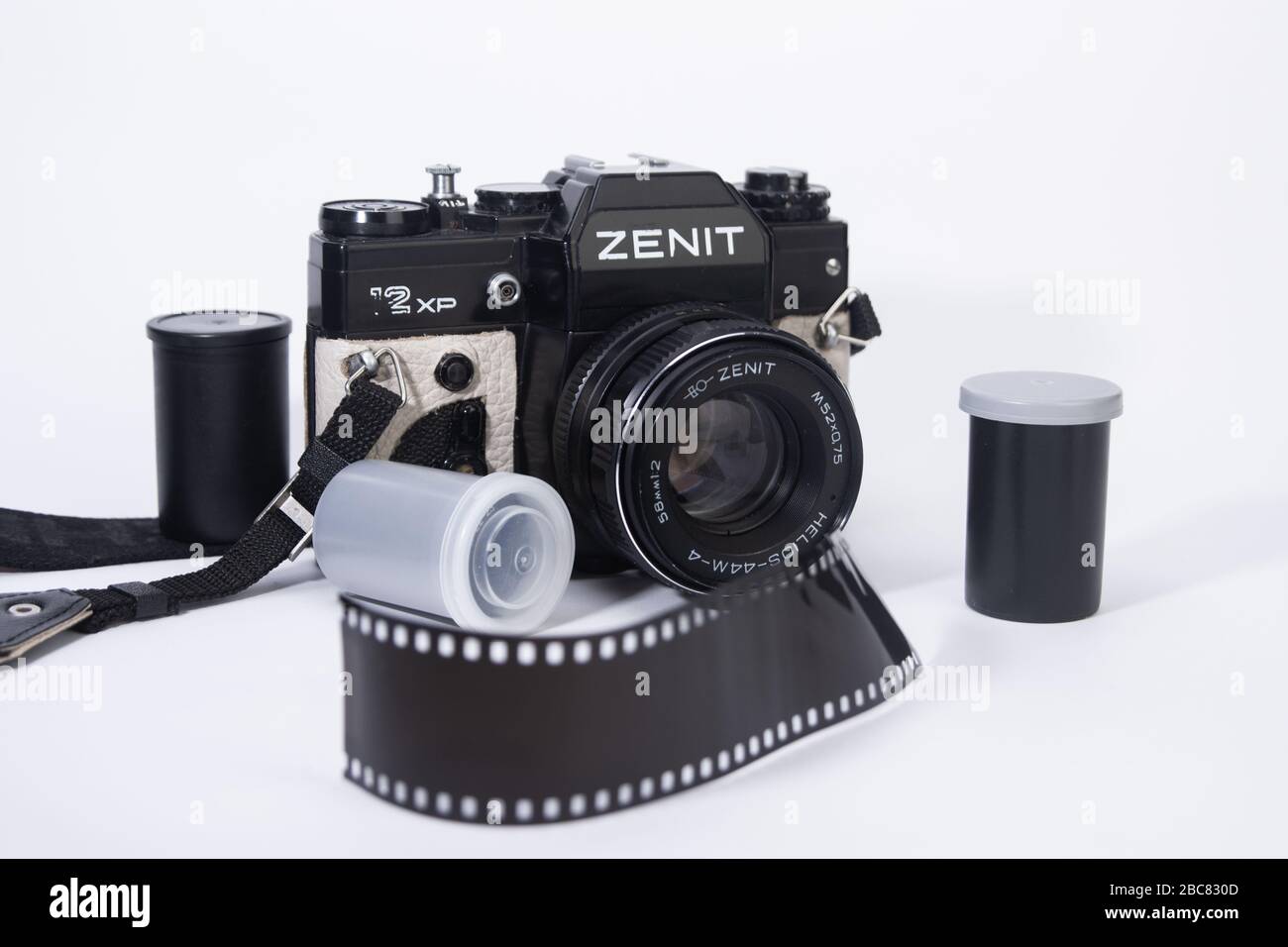 old school 35mm film camera, and camera lenses with film containers and