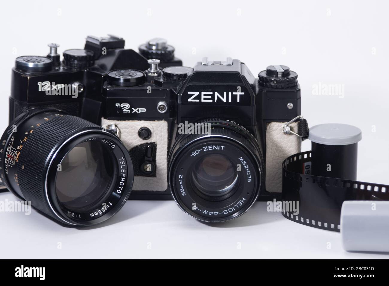 old school 35mm film camera, and camera lenses with film containers and