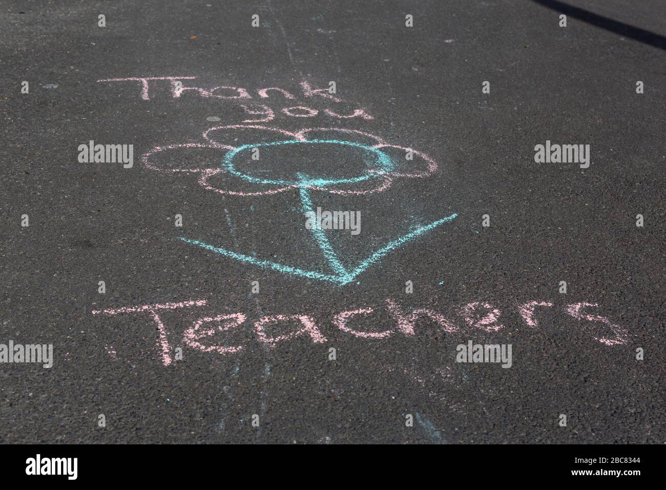 Carmarthen, UK. 3 April, 2020. Child's chalk graffiti on pavement saying Thank You Teachers as part of Clap for Carers initiative during Coronavirus pandemic lockdown in Wales, UK. Credit: Gruffydd Ll. Thomas/Alamy Live News Stock Photo