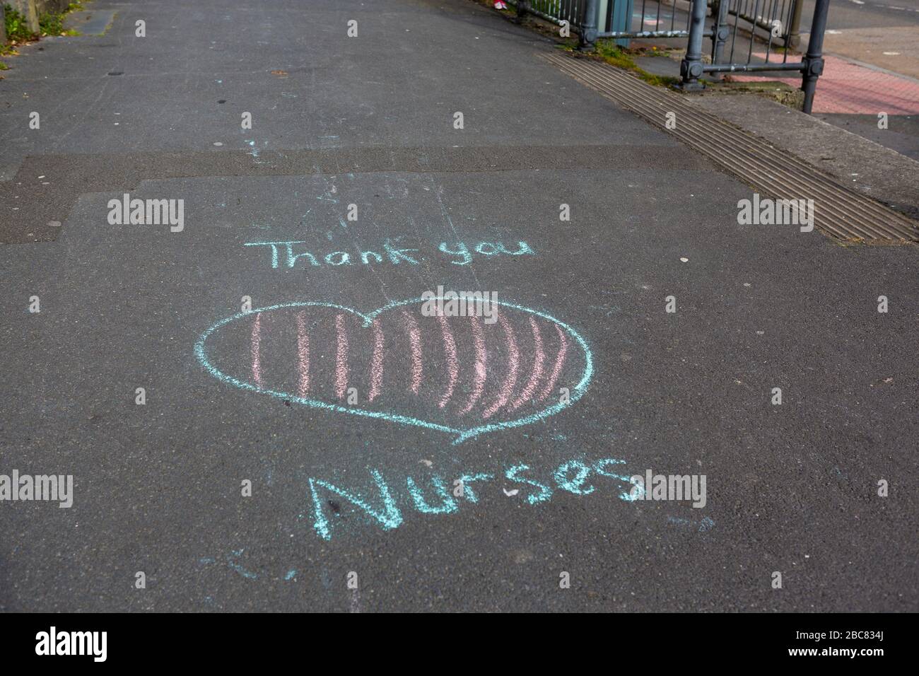 Carmarthen, UK. 3 April, 2020. Child's chalk graffiti on pavement saying Thank You Nurses as part of Clap for Carers initiative during Coronavirus pandemic lockdown in Wales, UK. Credit: Gruffydd Ll. Thomas/Alamy Live News Stock Photo