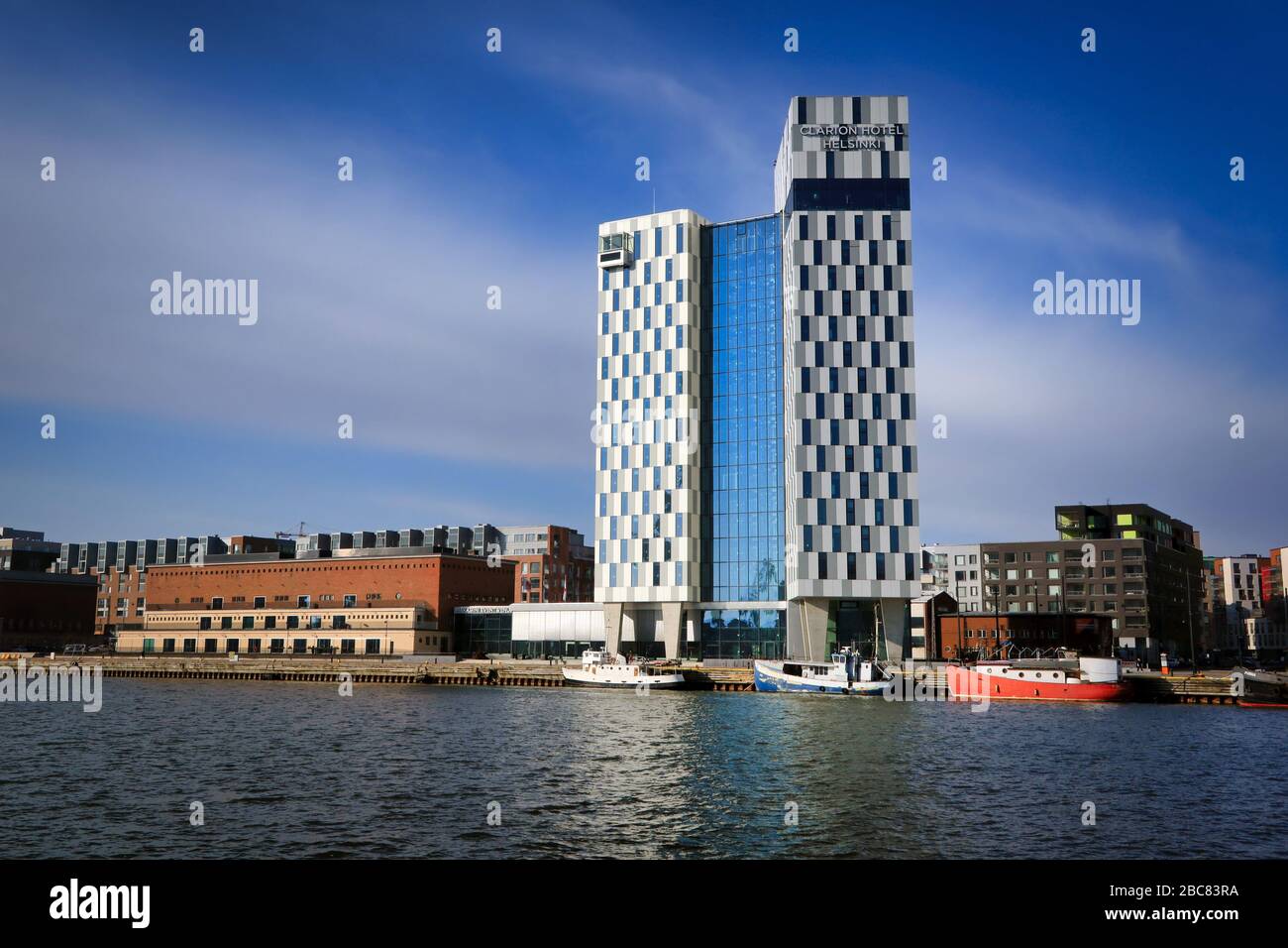 View of Hietalahti seafront with Clarion Hotel and city buildings on a sunny day. Helsinki, Finland. March 27, 2020. Stock Photo