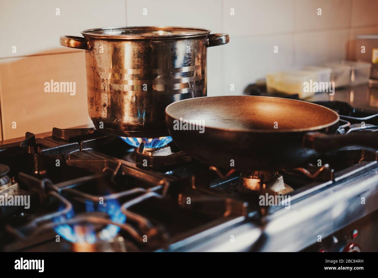 Frying pan heating on the kitchen gas stove Stock Photo Alamy
