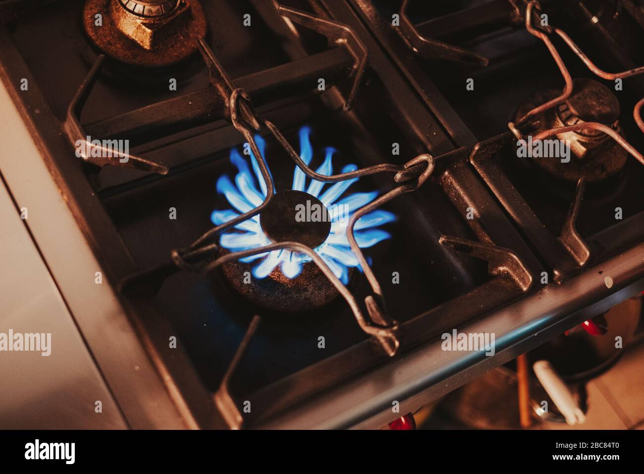 Kitchen gas stove blue flames Stock Photo Alamy