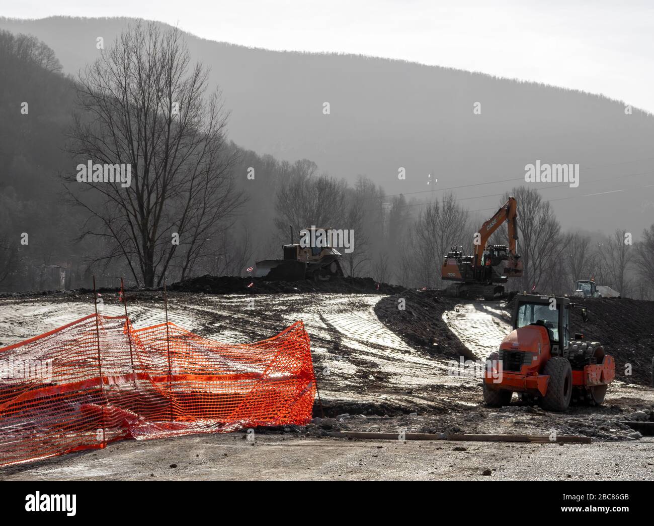 AULLA, NORTH TUSCANY, ITALY - February 12 2020: Excavation and earth moving works continue with heavy plant. Wet early morning. Stock Photo