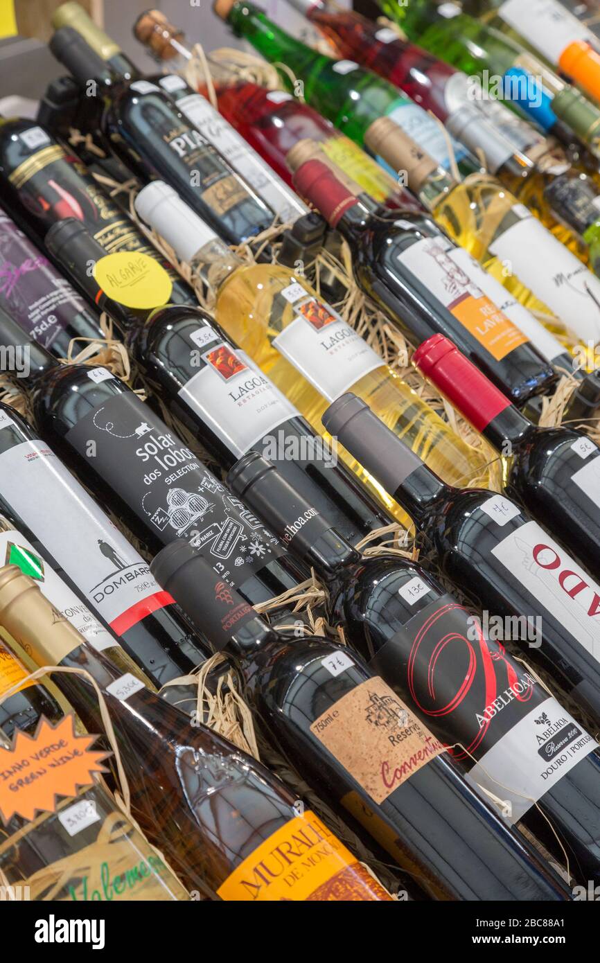 Bottles of wine on sale at stall in indoor market, Loule, Algarve, Portugal Stock Photo