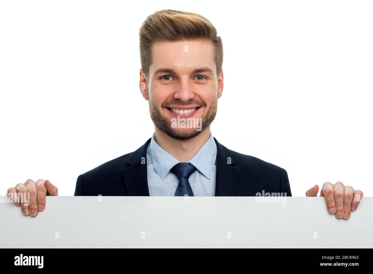 Business man holding white board Stock Photo