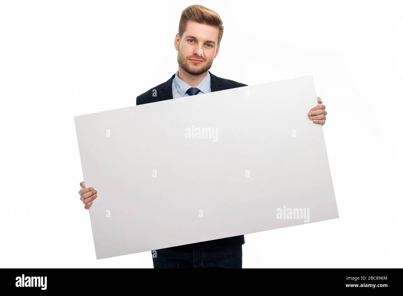 Business man holding white board Stock Photo