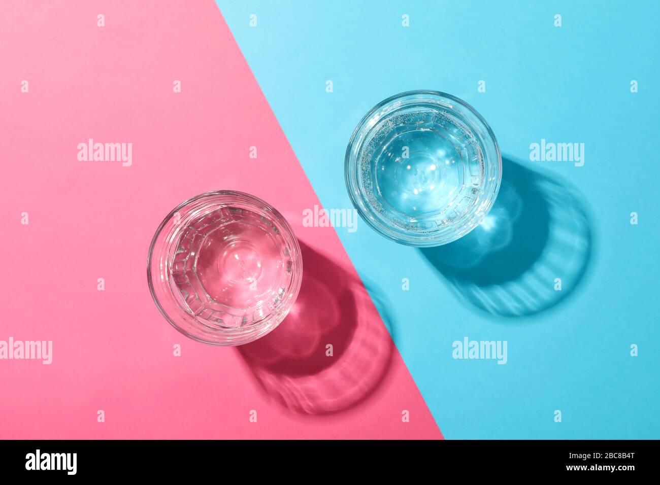 Glasses with water on two tone background, top view Stock Photo