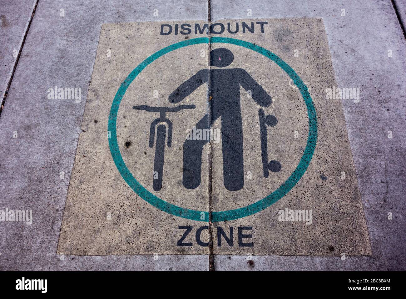 Dismount Zone Sign on the pavement in the Boulder Mall, Boulder, Colorado, USA Stock Photo