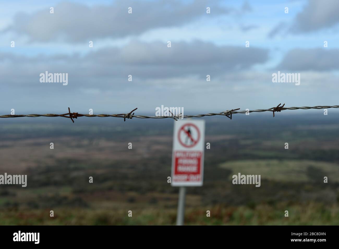 Barbed wire and an MOD sign on a firing range in Dorset. Stock Photo