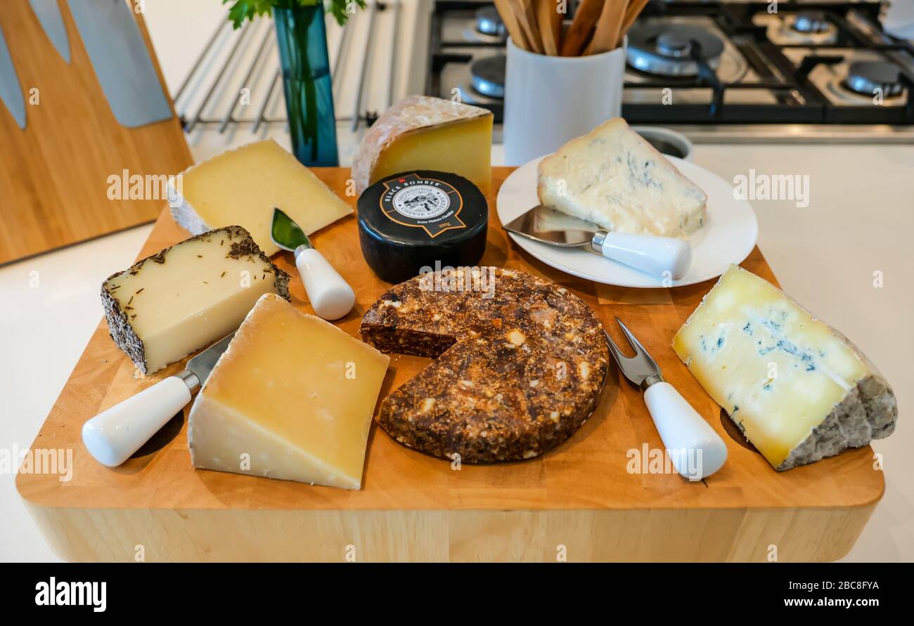 Cheese board: Spanish sheep's cheese, Gorgonzola, Manchego, Mahon, Cornish Blue, Corra Linn, Black Bomber mature cheddar & Pan de Higo fig almond cake Stock Photo