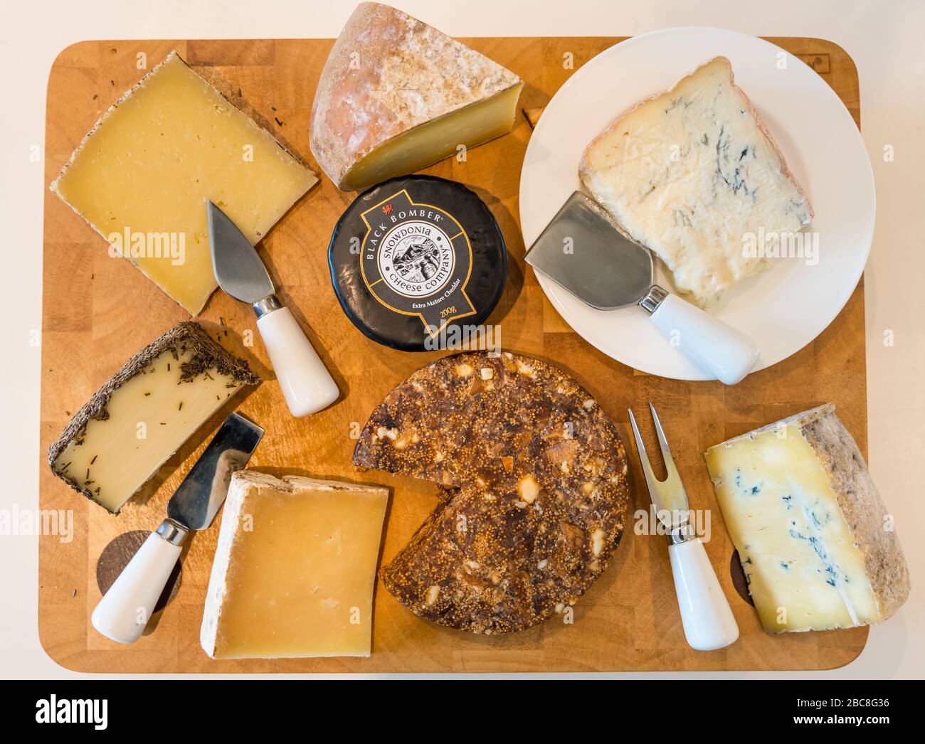 Cheese board: Spanish sheep's cheese, Gorgonzola, Manchego, Mahon, Cornish Blue, Corra Linn, Black Bomber mature cheddar & Pan de Higo fig almond cake Stock Photo