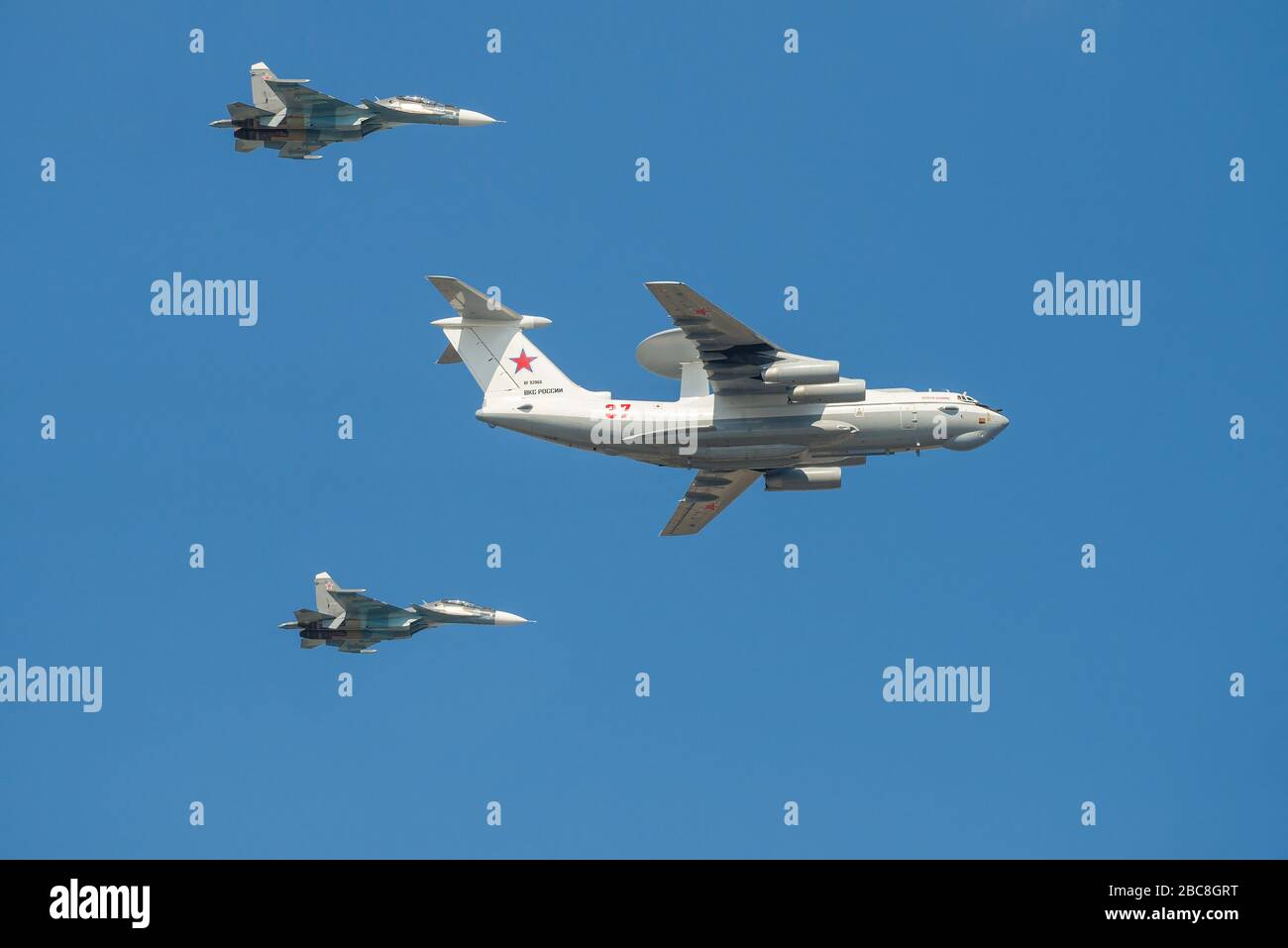 ST. PETERSBURG, RUSSIA - JULY 25, 2019: Aircraft A-50 'Liska' (RF-93966), accompanied by two Su-30SM multirole fighters. Fragment of a military parade Stock Photo