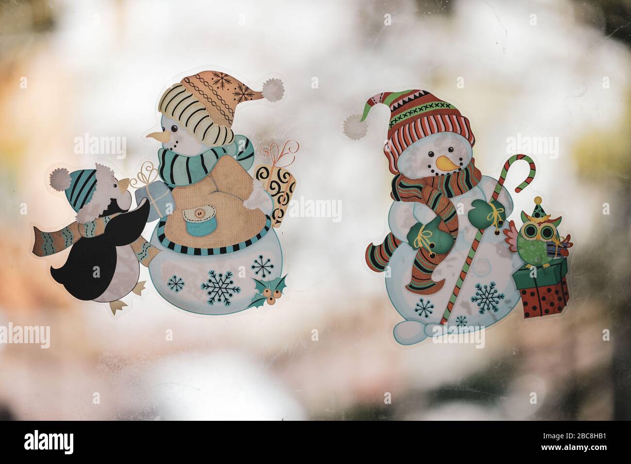 Bucharest, Romania - April 3, 2020: Details with Christmas theme stickers on a dirty window. Stock Photo