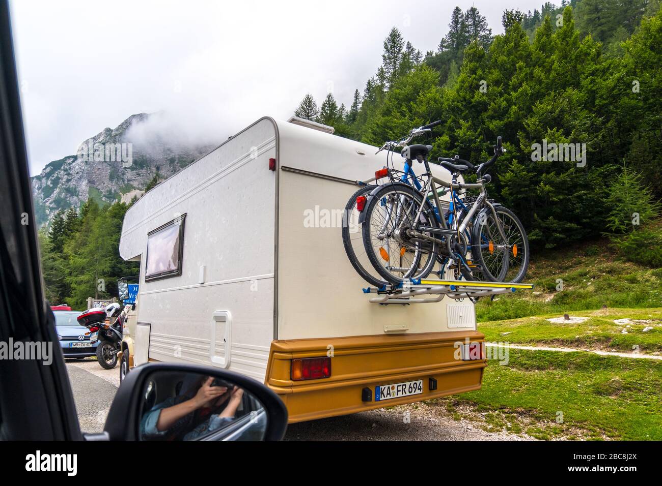 Bovec, Slovenia - August 11, 2019: Camper van with bike mount on mountain road in Julian Alps, Triglav National Park in Slovenia Stock Photo