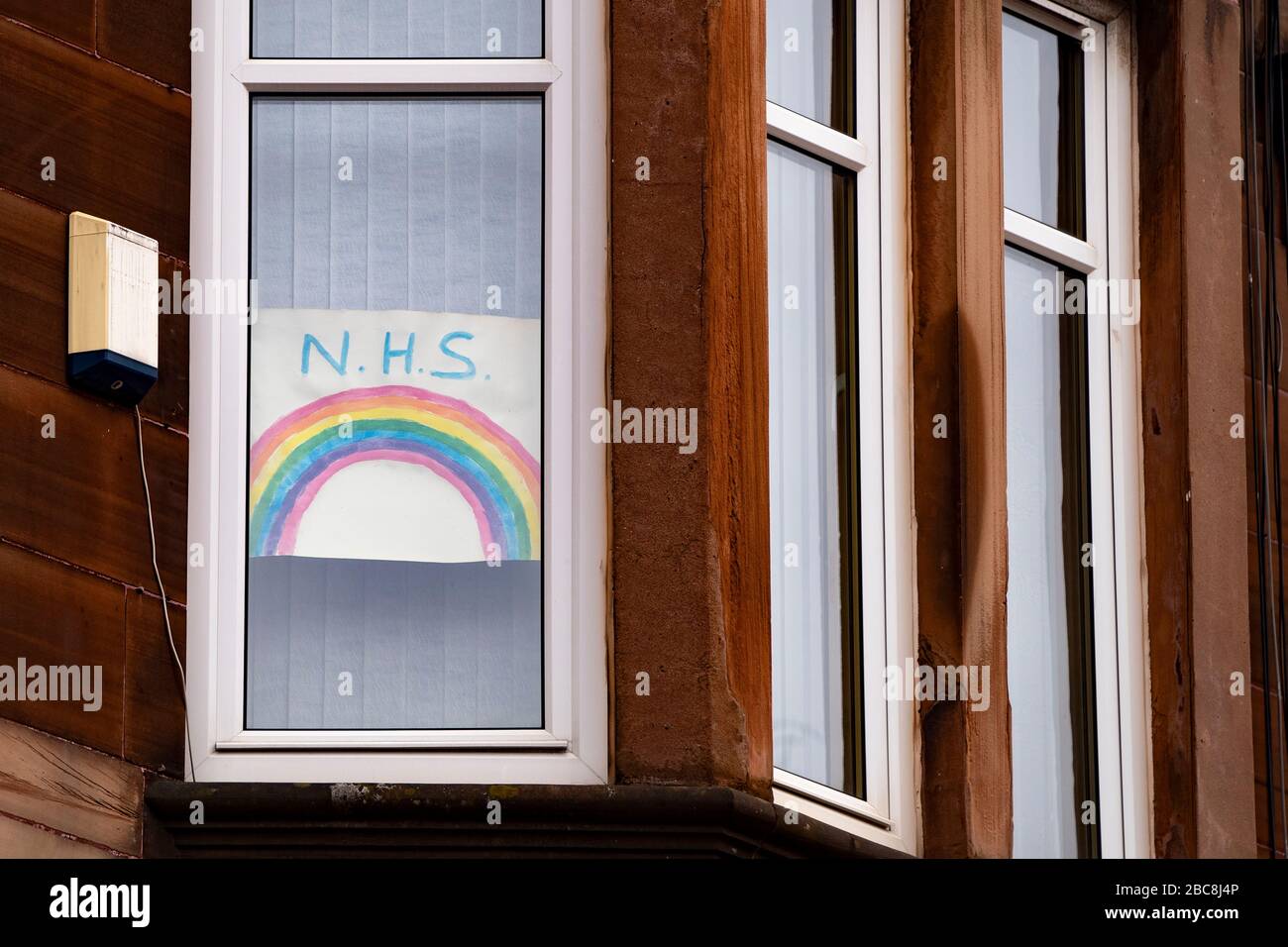 Glasgow, Scotland, UK. 3 April, 2020. Images from the south side of Glasgow at the end of the second week of Coronavirus lockdown. Pictured; hand drawn rainbow NHS message in window of flat in Govanhill . Iain Masterton/Alamy Live News Stock Photo