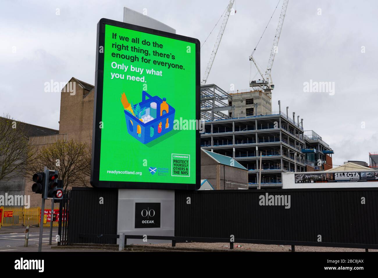 Glasgow, Scotland, UK. 3 April, 2020. Images from the south side of Glasgow at the end of the second week of Coronavirus lockdown. Large video screen in Tradeston with public information message about hoarding food during coronavirus pandemic. Iain Masterton/Alamy Live News Stock Photo