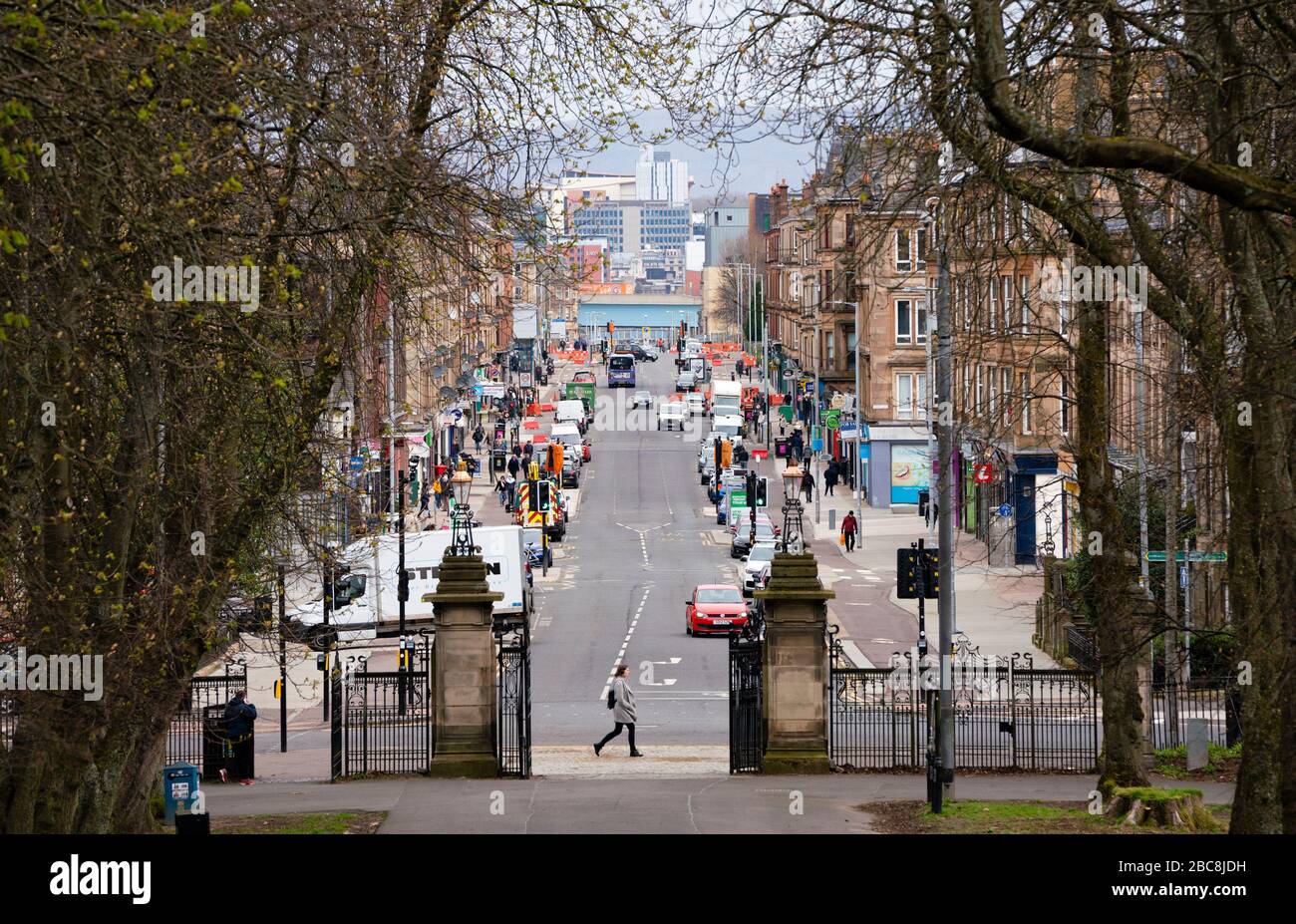 Glasgow, Scotland, UK. 3 April, 2020. Images from the south side of Glasgow at the end of the second week of Coronavirus lockdown.  Jogger runs past a very quiet Victoria Road in Govanhill.  Iain Masterton/Alamy Live News Stock Photo