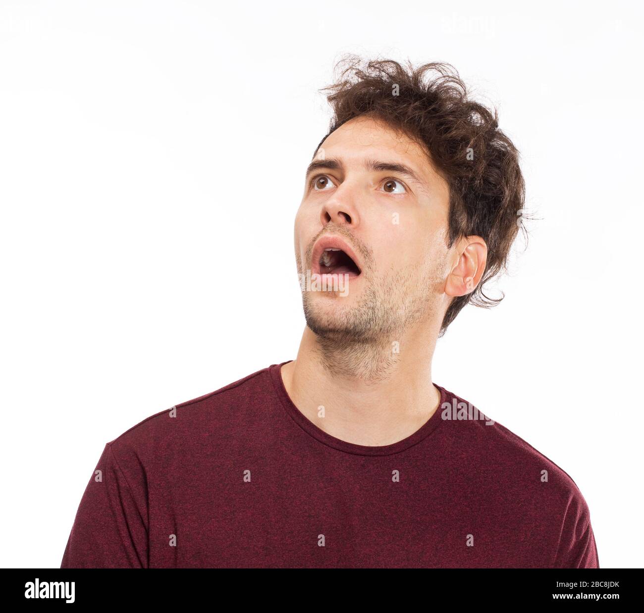 Portrait of young man with shocked facial expression Stock Photo