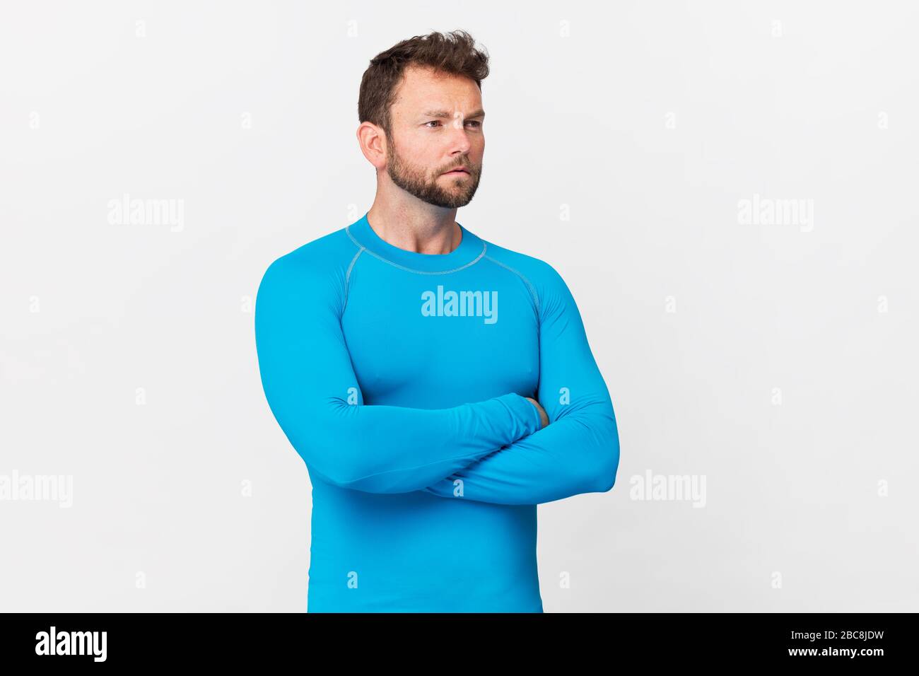 Handsome man in blue sport costume portrait against white background Stock Photo