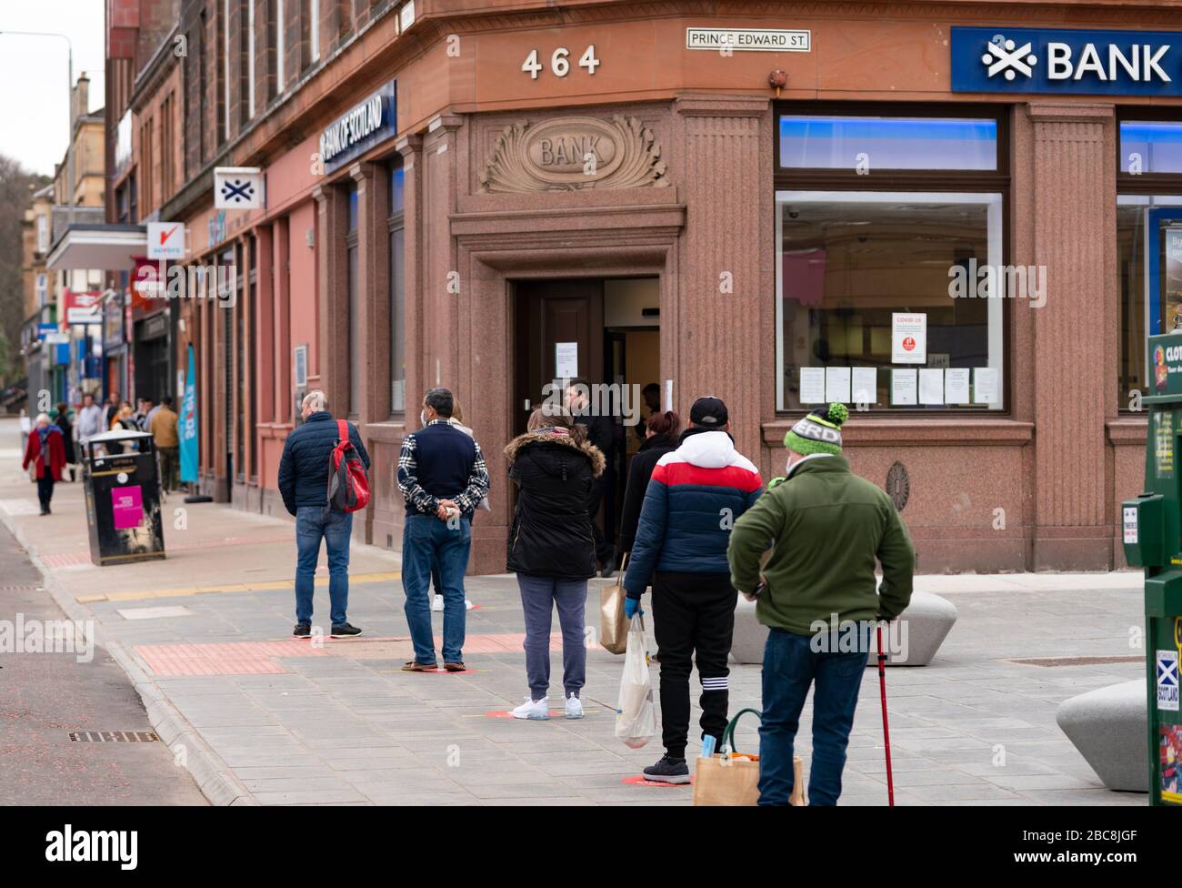 Glasgow, Scotland, UK. 3 April, 2020. Images from the south side of Glasgow at the end of the second week of Coronavirus lockdown. Customers queue to enter the Bank of Scotland branch on Victoria Road, Govanhill. Iain Masterton/Alamy Live News Stock Photo