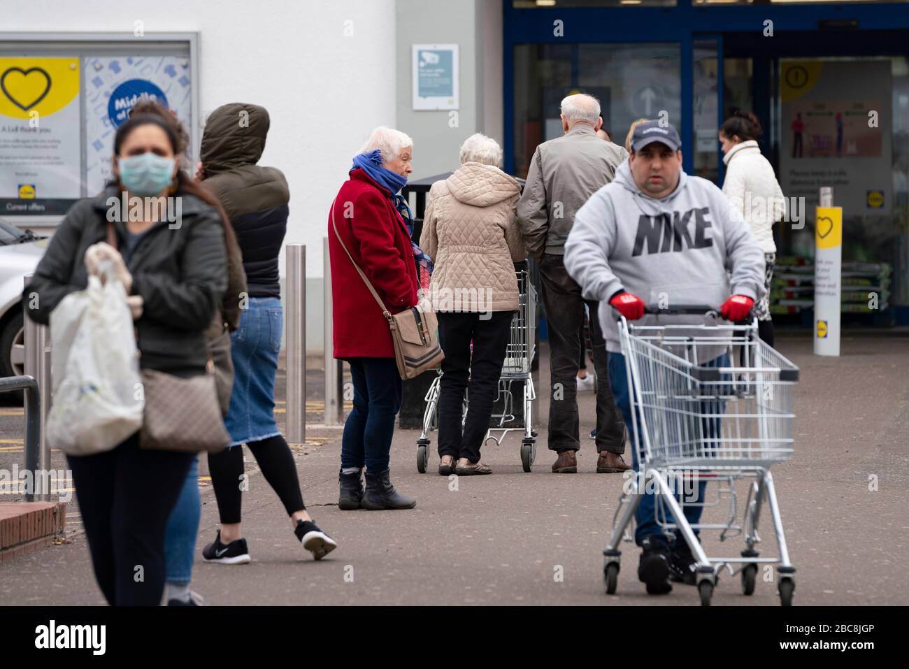 Glasgow, Scotland, UK. 3 April, 2020. Images from the south side of Glasgow at the end of the second week of Coronavirus lockdown. Long queue outside Lidl supermarket in Govanhill.  Iain Masterton/Alamy Live News Stock Photo
