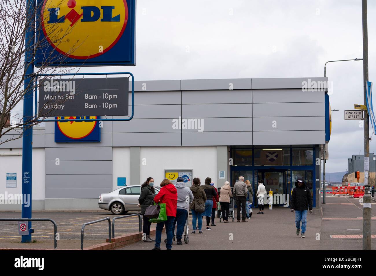 Glasgow, Scotland, UK. 3 April, 2020. Images from the south side of Glasgow at the end of the second week of Coronavirus lockdown. Long queue outside Lidl supermarket in Govanhill.  Iain Masterton/Alamy Live News Stock Photo
