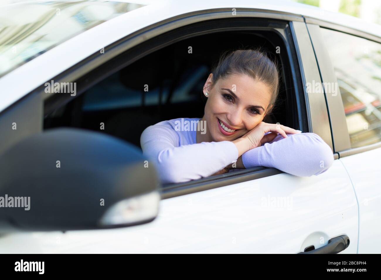 Young woman sitting in a car Stock Photo