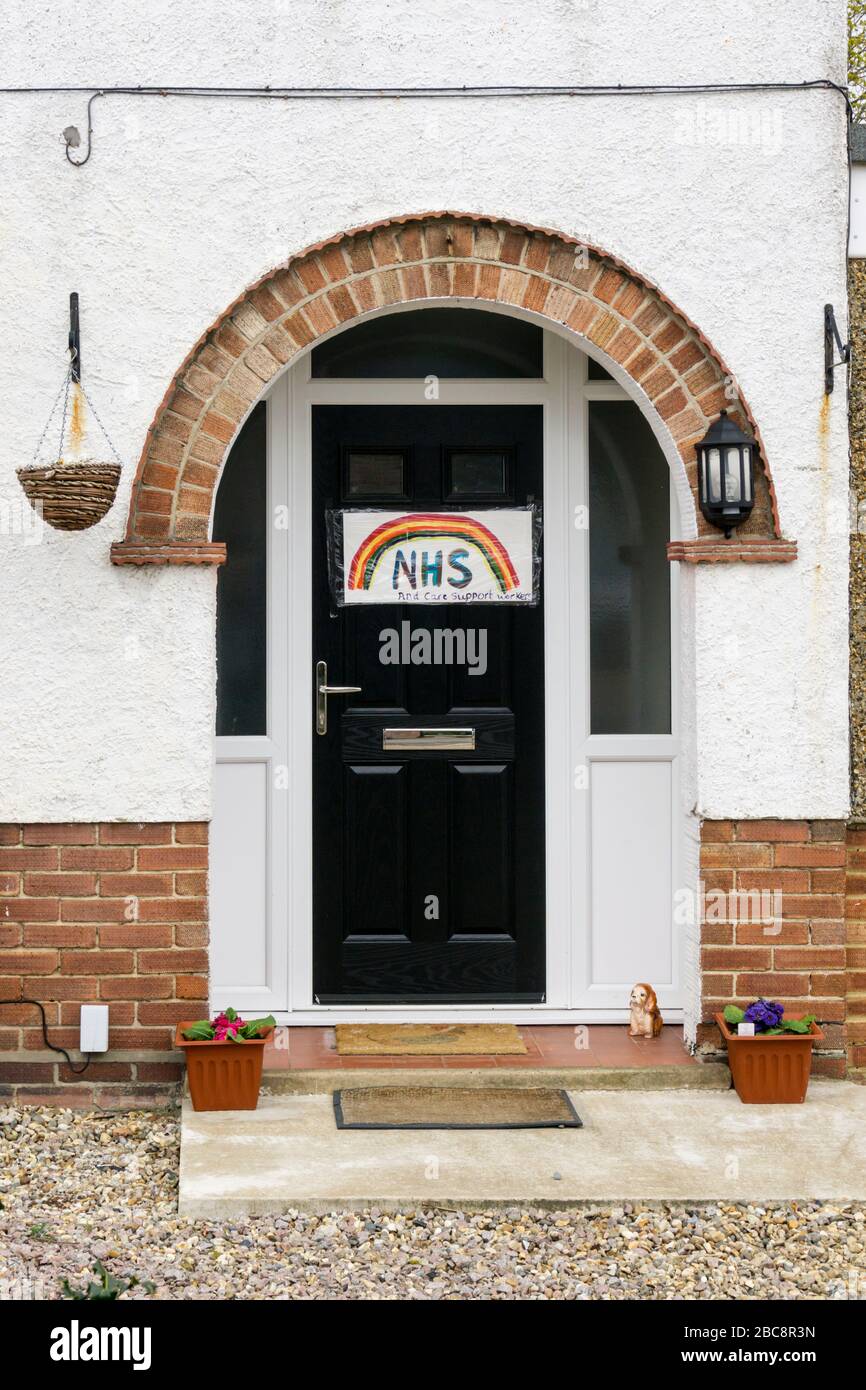 A homemade sign on a door offers support to the NHS and care support workers during the 2020 Covid 19 Coronavirus pandemic. Stock Photo