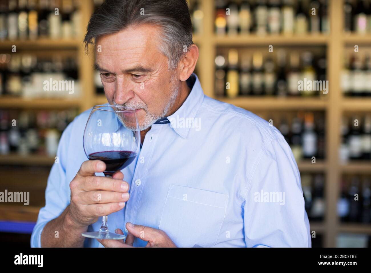 Man working in wine shop Stock Photo
