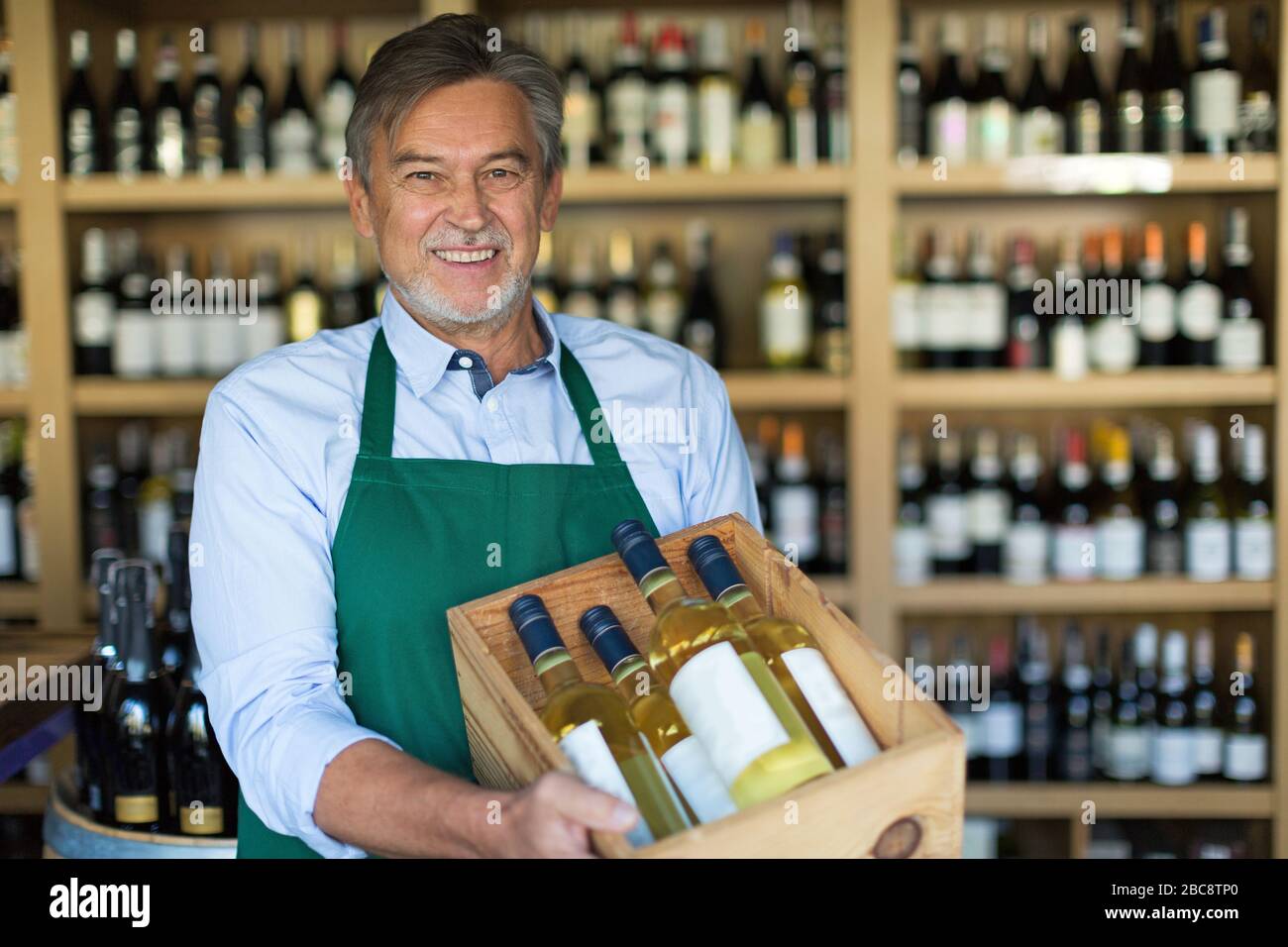 Man working in wine shop Stock Photo
