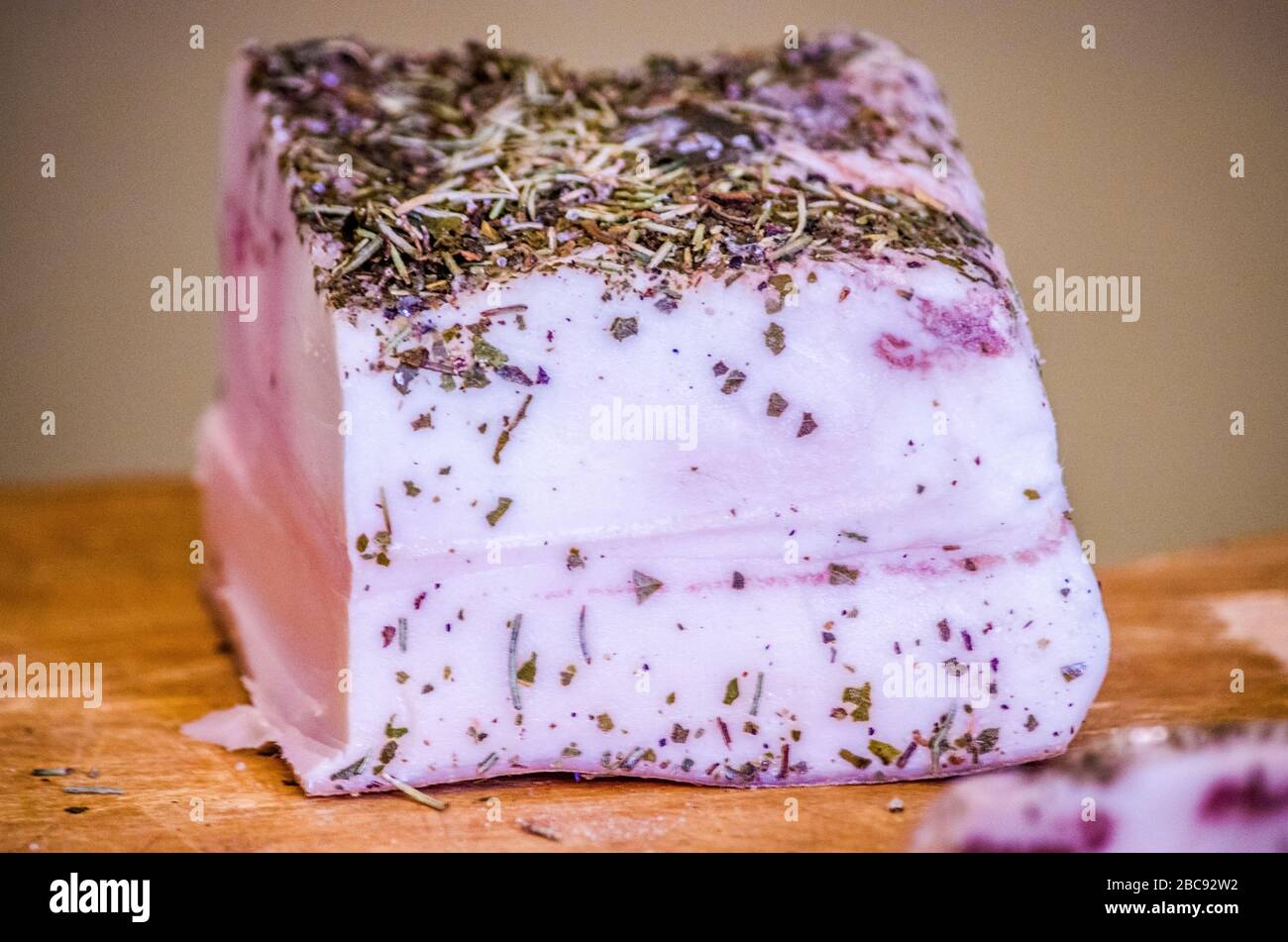 seasoned lard in a cave with aromatic herbs ready to flavor your delicious dishes Stock Photo